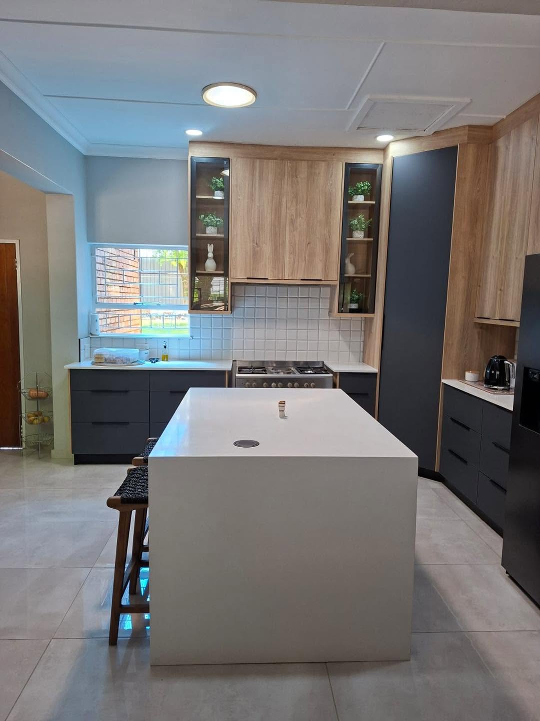 Oak and charcoal kitchen with waterfall quartz island