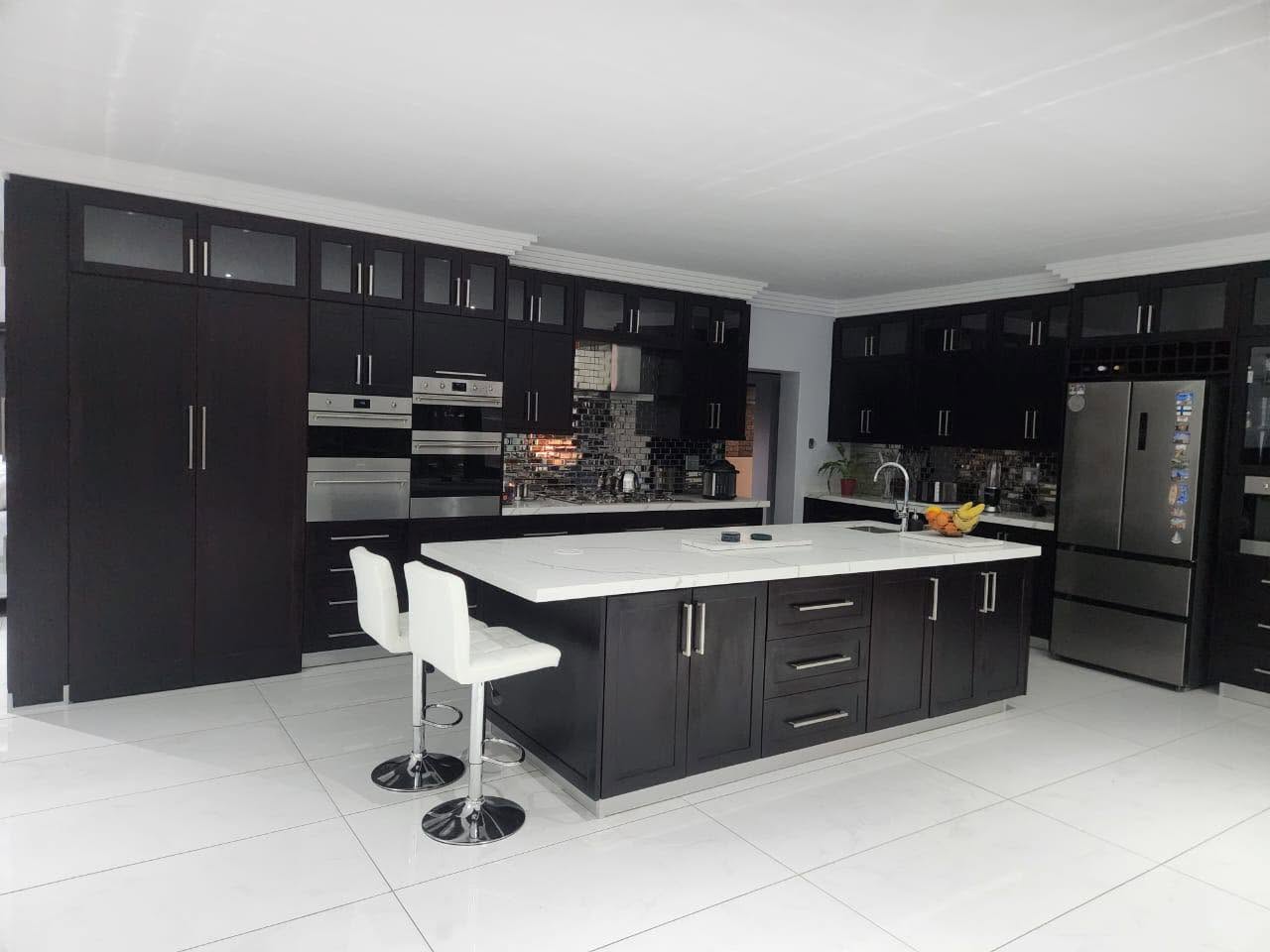 Dramatic dark espresso kitchen with large white quartz island