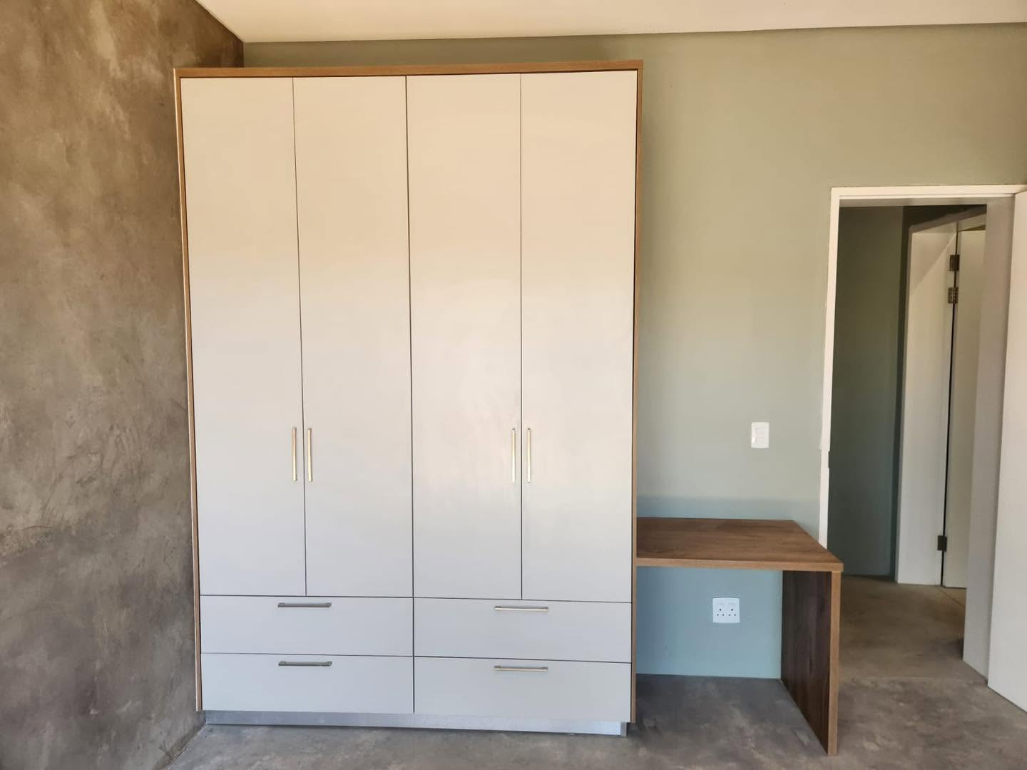 Cream cupboards with oak frame and matching study desk