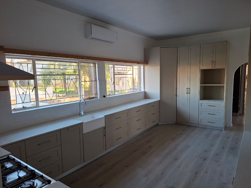 Light oak laminate flooring in renovated kitchen