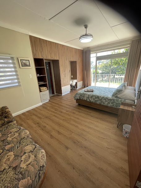 Warm oak vinyl plank flooring in main bedroom
