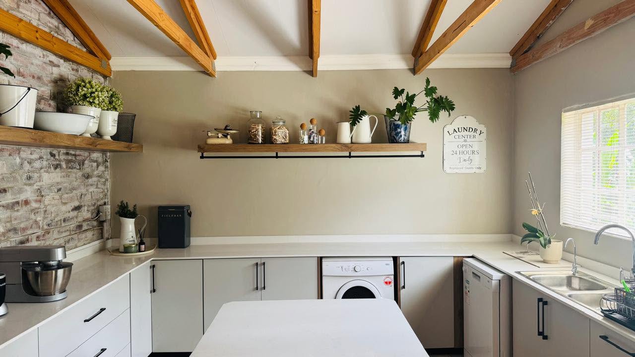 Farmhouse kitchen with exposed beams and brick feature wall