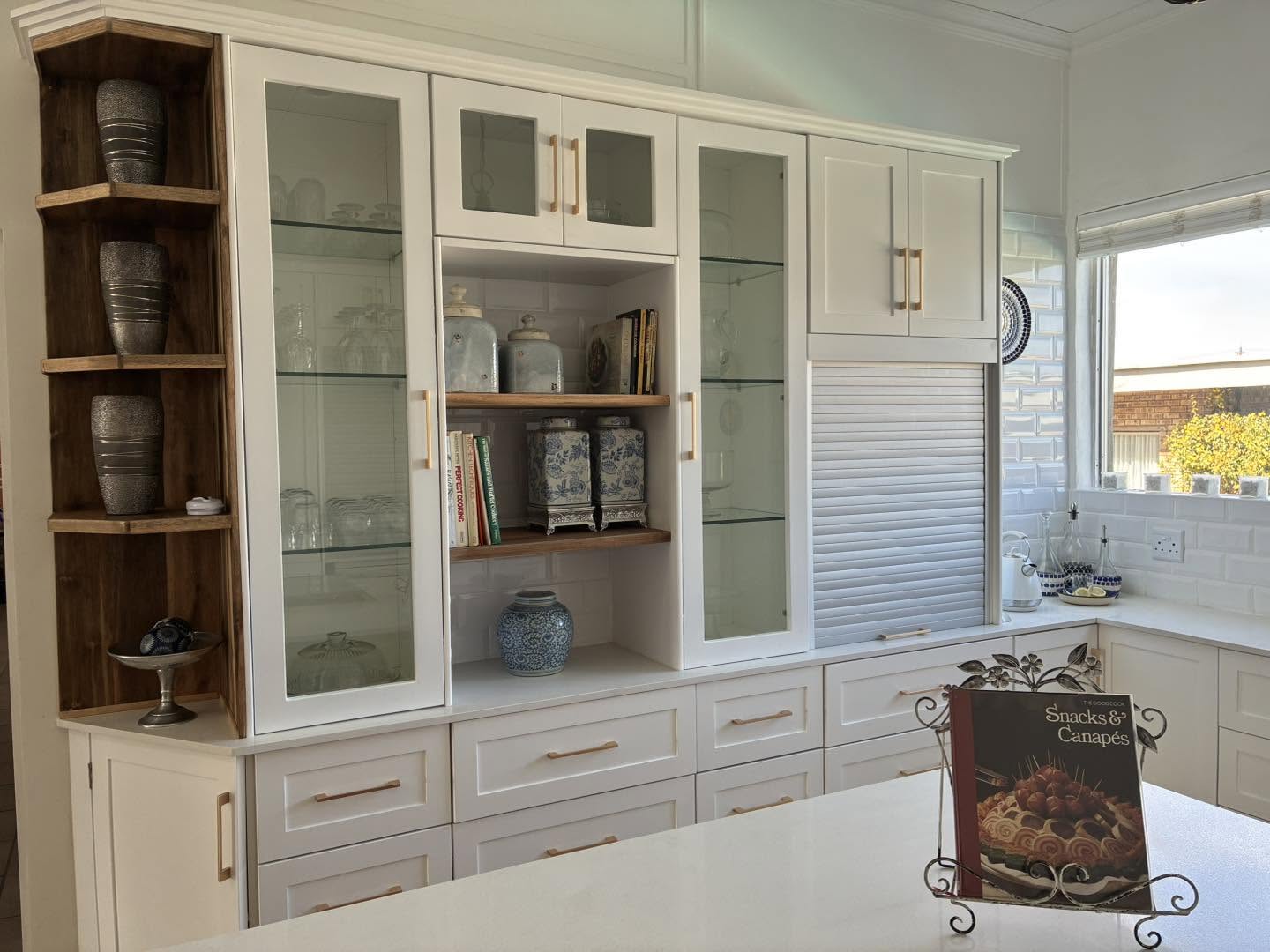 Built-in glass display cabinetry with timber shelving