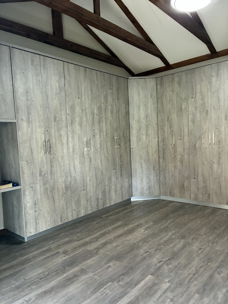 Grey wood-look vinyl flooring in cupboard-lined room
