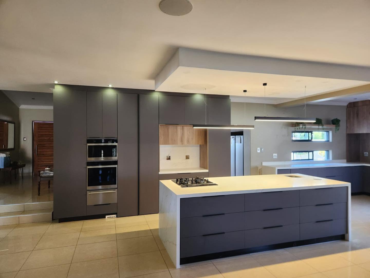 Sleek charcoal kitchen with twin islands and pendant lighting