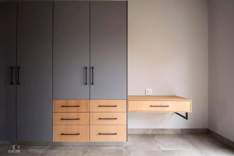 Charcoal cupboards with oak drawer feature and floating side desk
