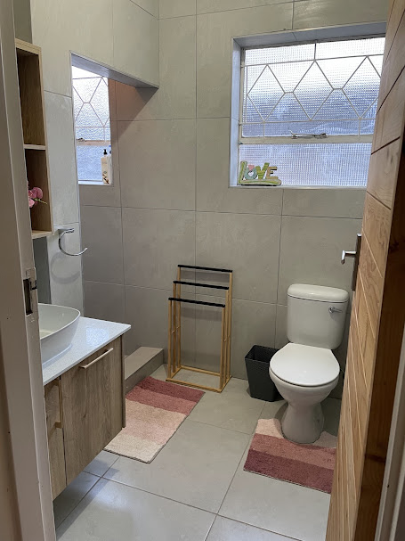 Guest bathroom with large-format tiles and oak vanity